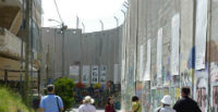 leed pilgrim in Bethlehem alongside the Separation Barrier