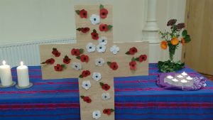 red and white poppies on a cross