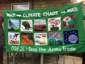 A banner about militarism and climate change