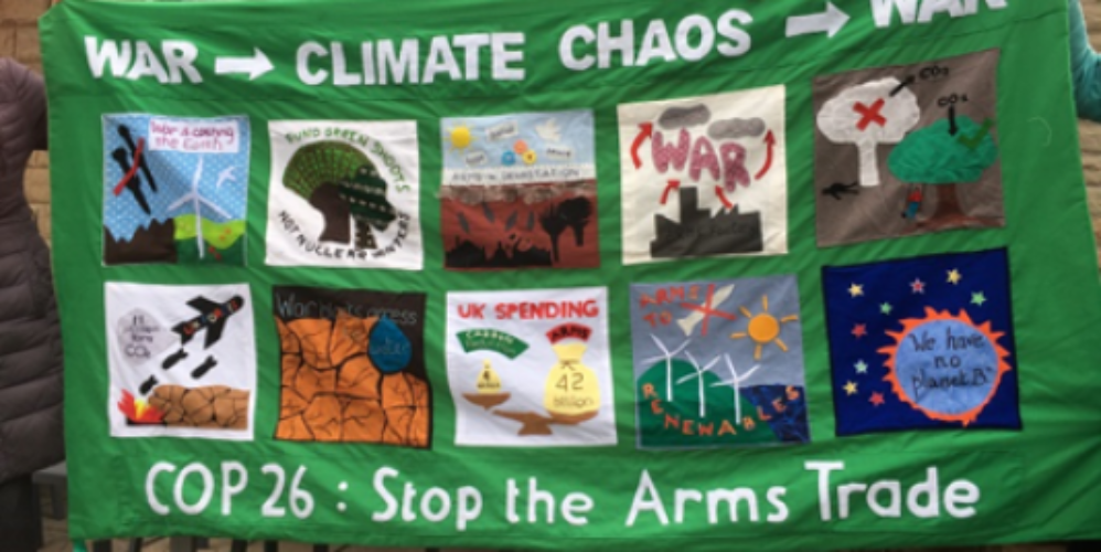 A banner about militarism and climate change