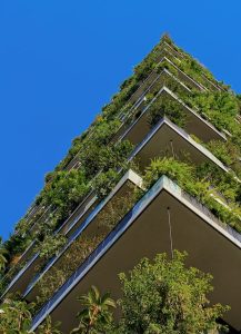 a tall building with lots of greenery incorporated